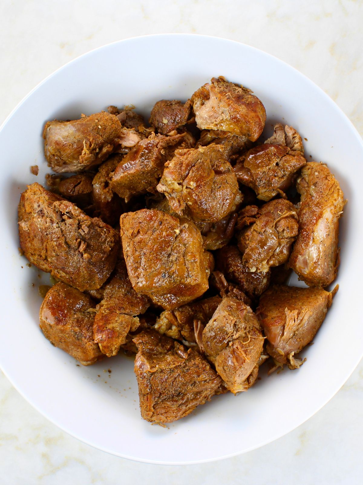 A plate of cooked pork roast before it is shredded.