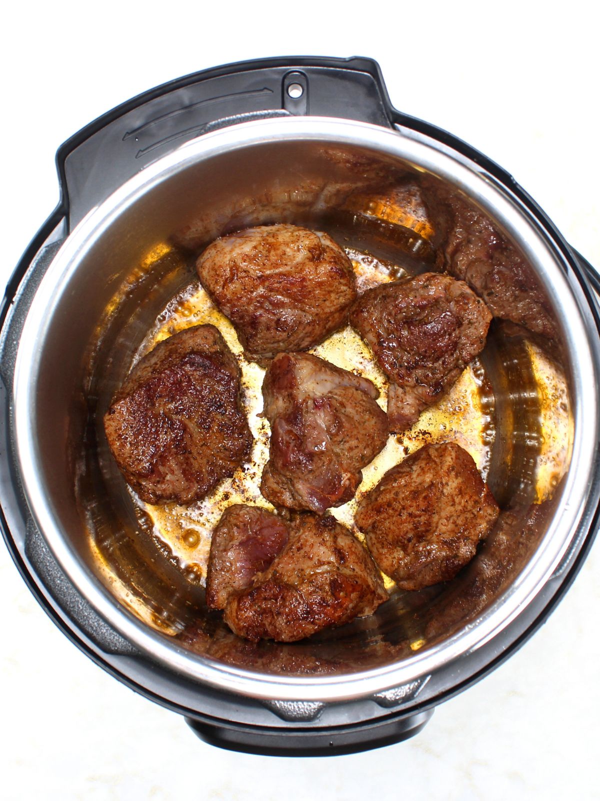 Searing the cut up roast in the instant pot.