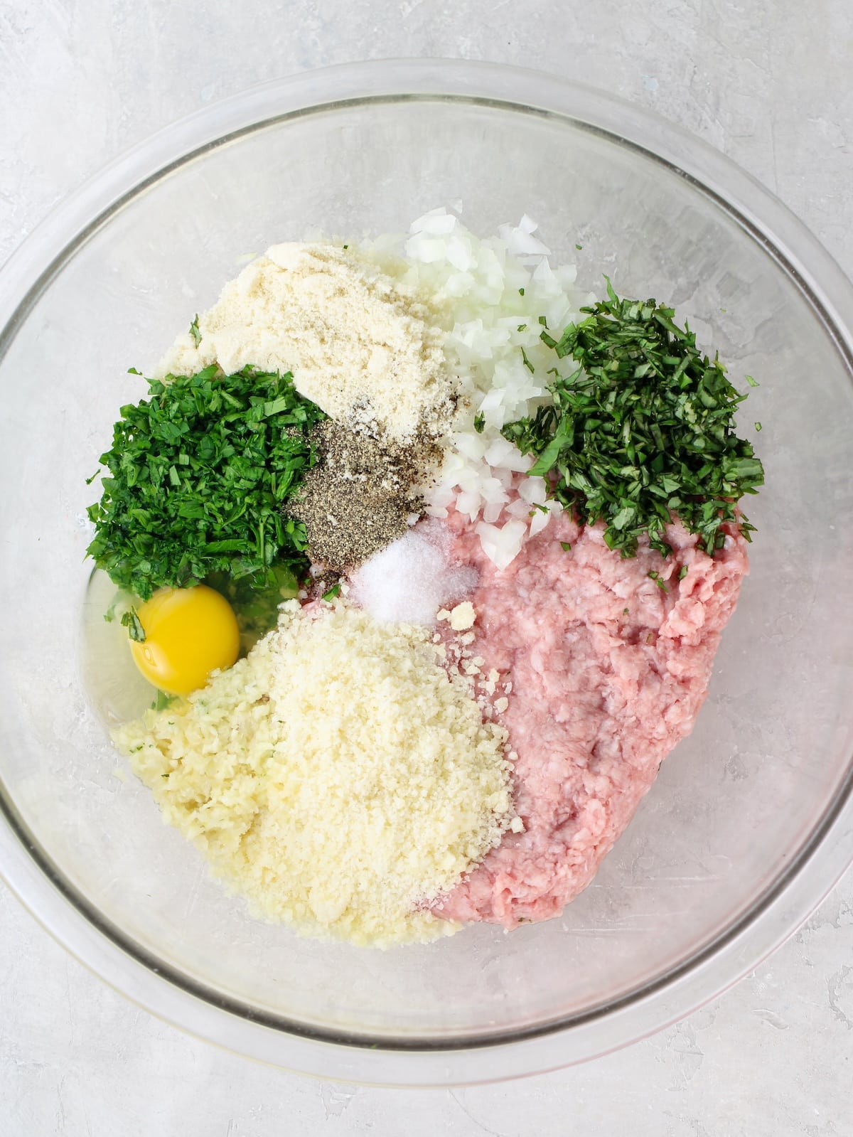 All the ingredients for the Italian meatball recipe in a large bowl.