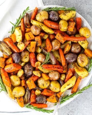 Lots of roasted root vegetables on platter.