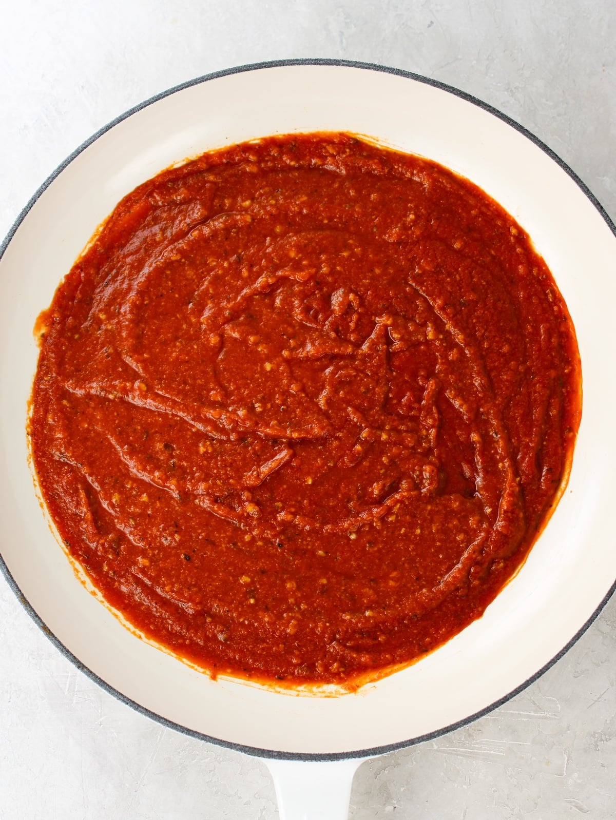 Tomato sauce in a pan for meatball recipe.