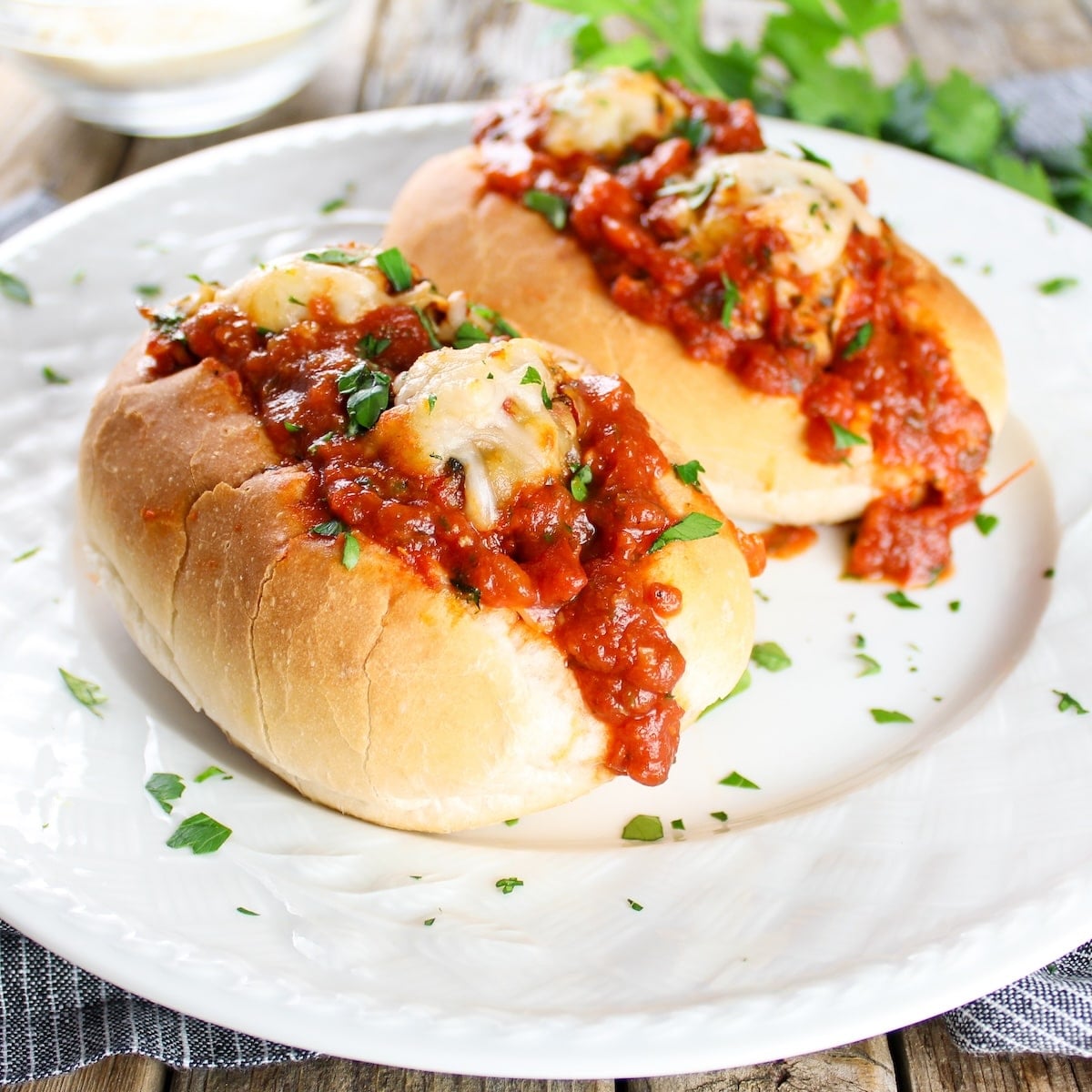 The Best Italian meatball subs with sauce on a plate.