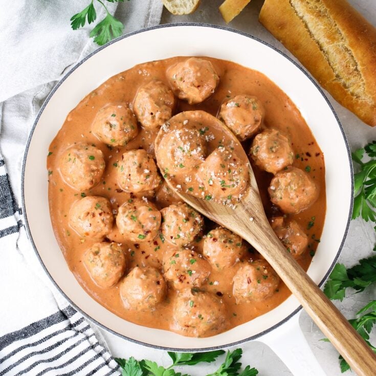 Homemade meatballs in sauce with parmesan cheese.