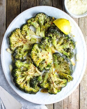 A 1200x1200 photos of Roasted Parmesan Broccoli with garlic and red chili pepper flakes.