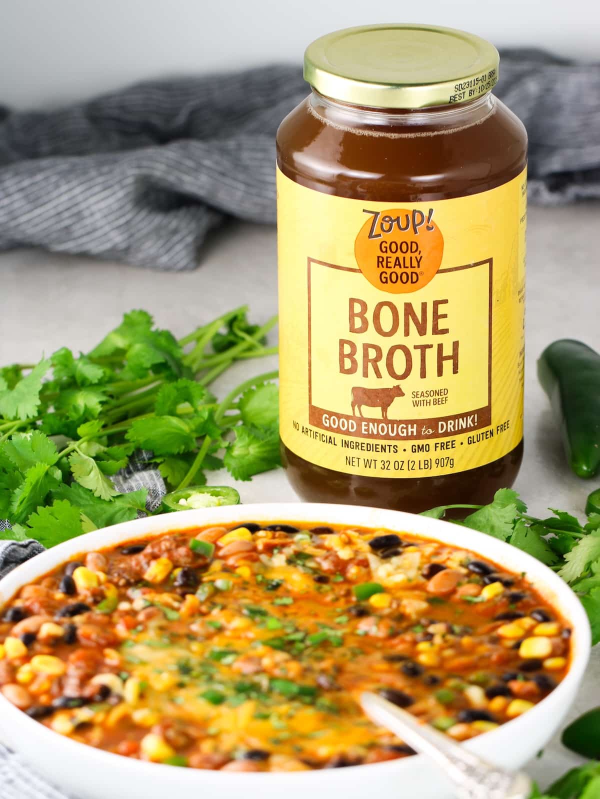 Zoup! Beef Bone Broth with a bowl of Homemade Taco Soup next to it.