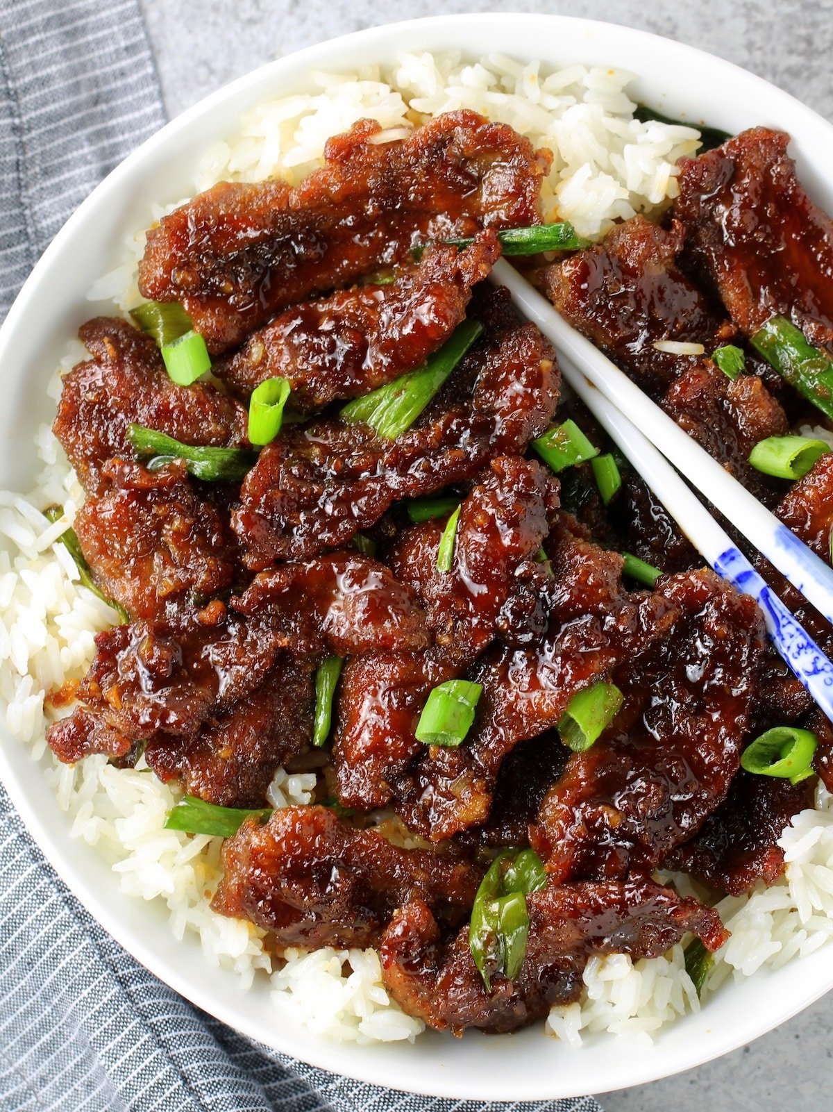 30-Minute Mongolian Beef A close up of a plate of food with cooked thinly sliced steak tossed in Mongolian beef sauce.