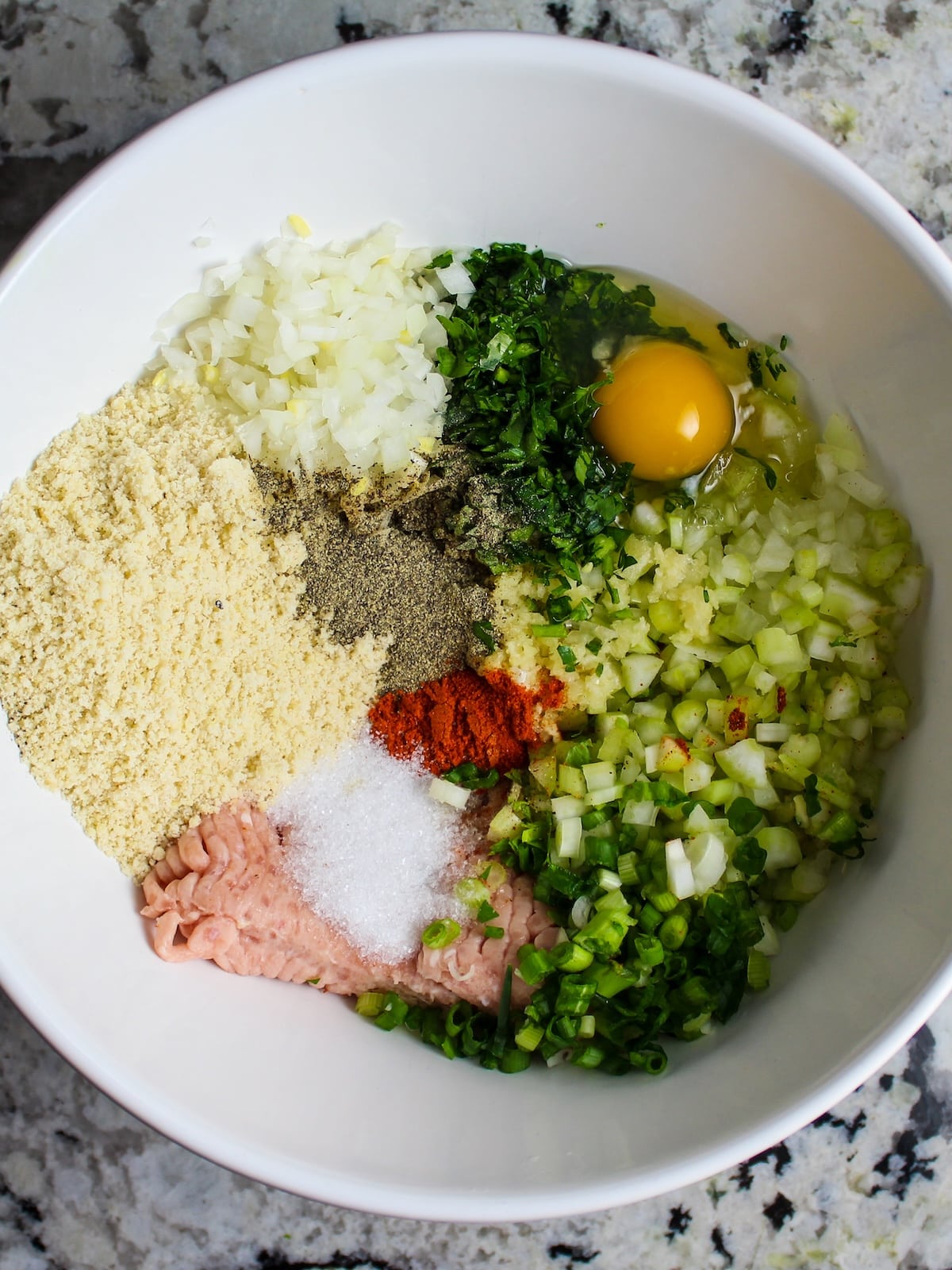 All the ingredients for buffalo chicken meatballs in a mixing bowl.