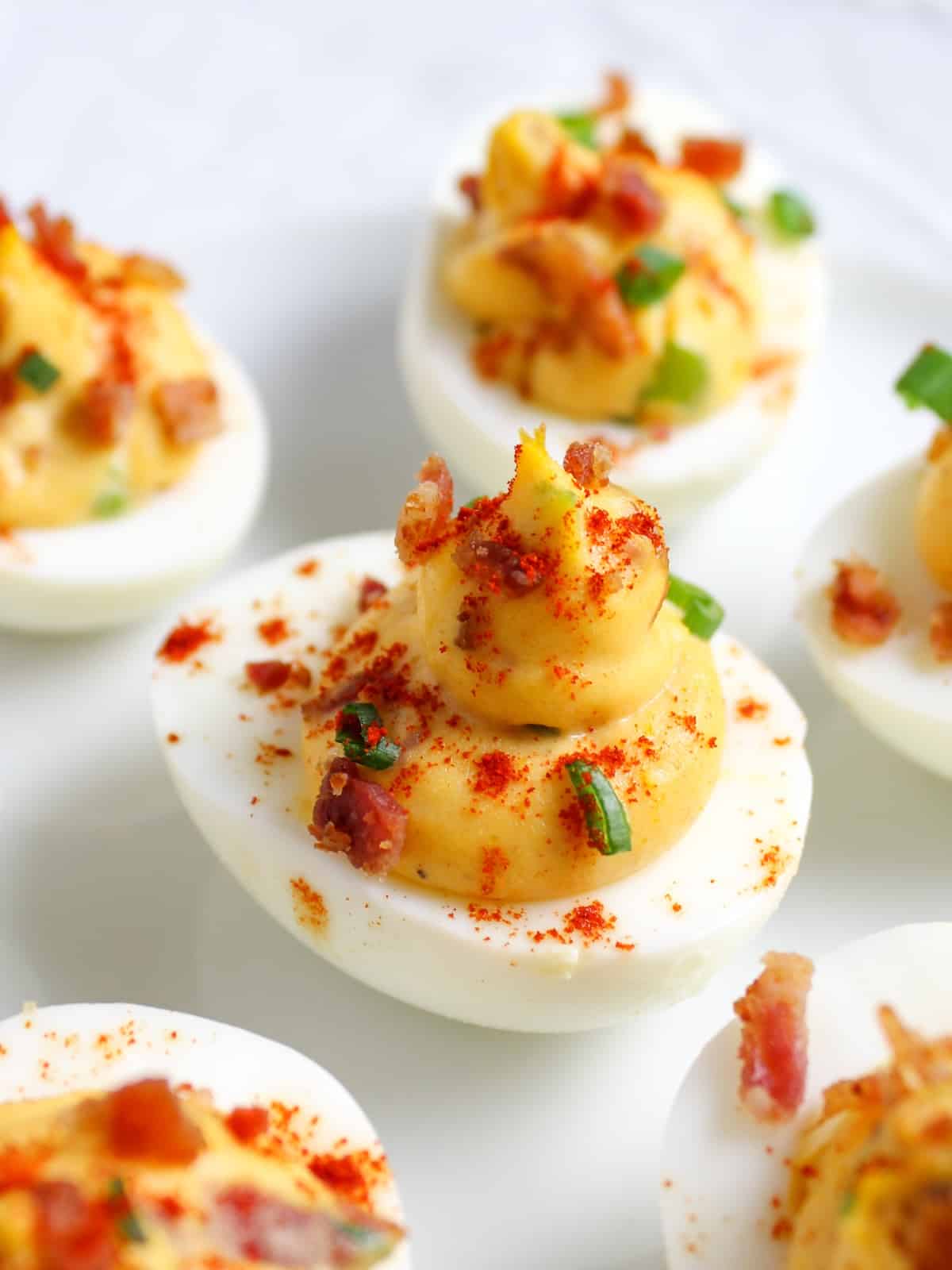 Smoky Deviled Eggs with Bacon on platter A close-up photo of smoky deviled eggs with bacon.