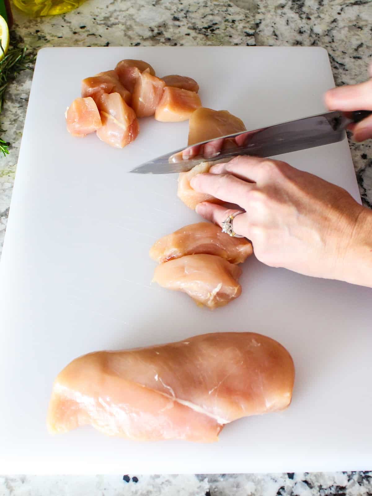 Cutting up chicken breasts for the recipe.
