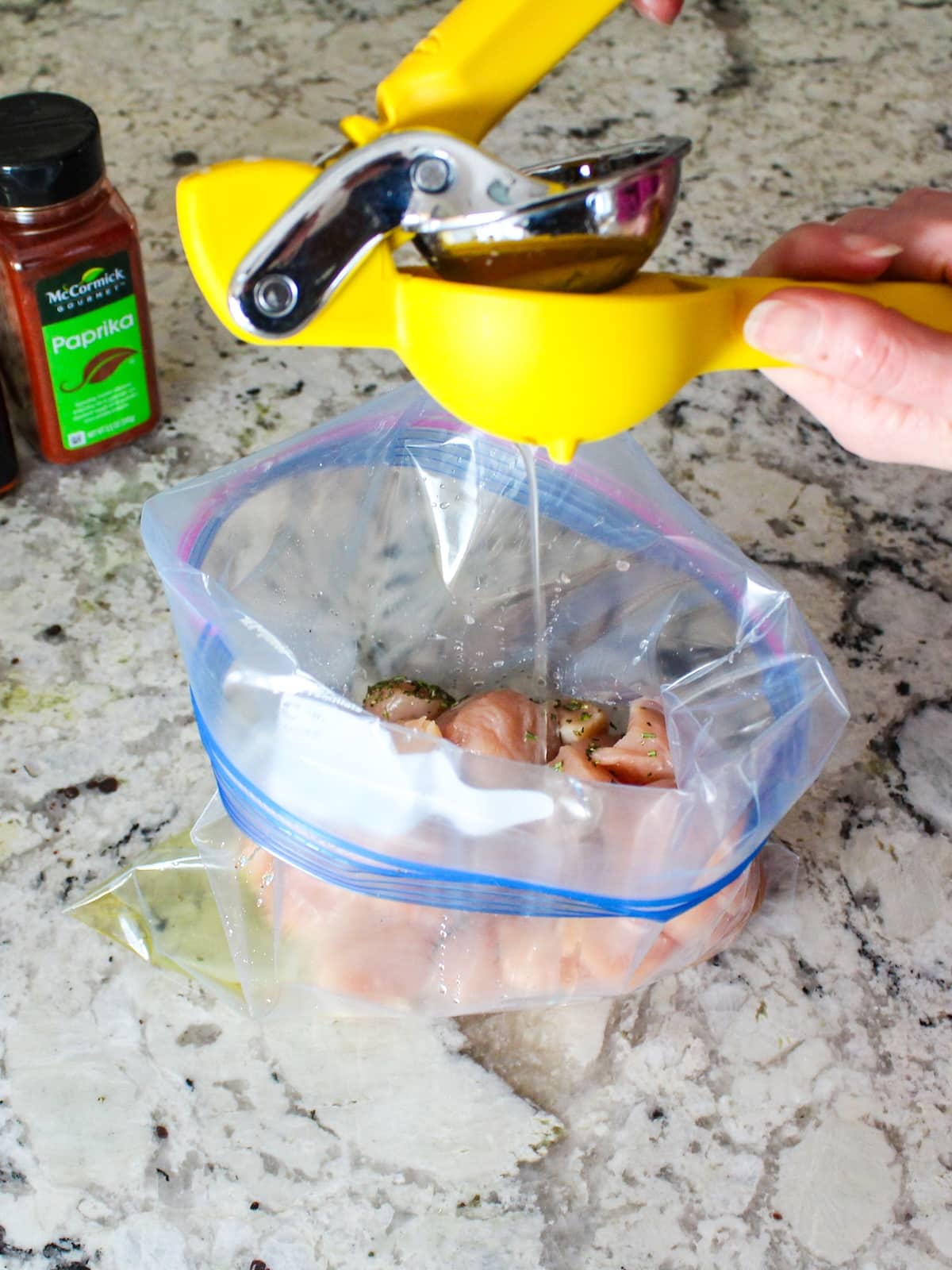 Squeezing lemon into the marinade for the boneless skinless chicken breasts.