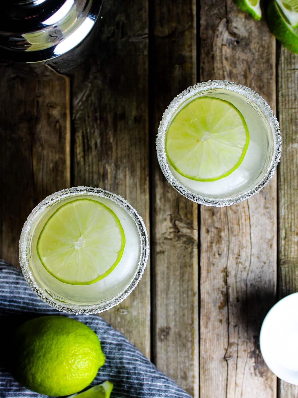 St Germain Margarita And over the top photo of two St Germain margaritas made with limes and a salt rim.
