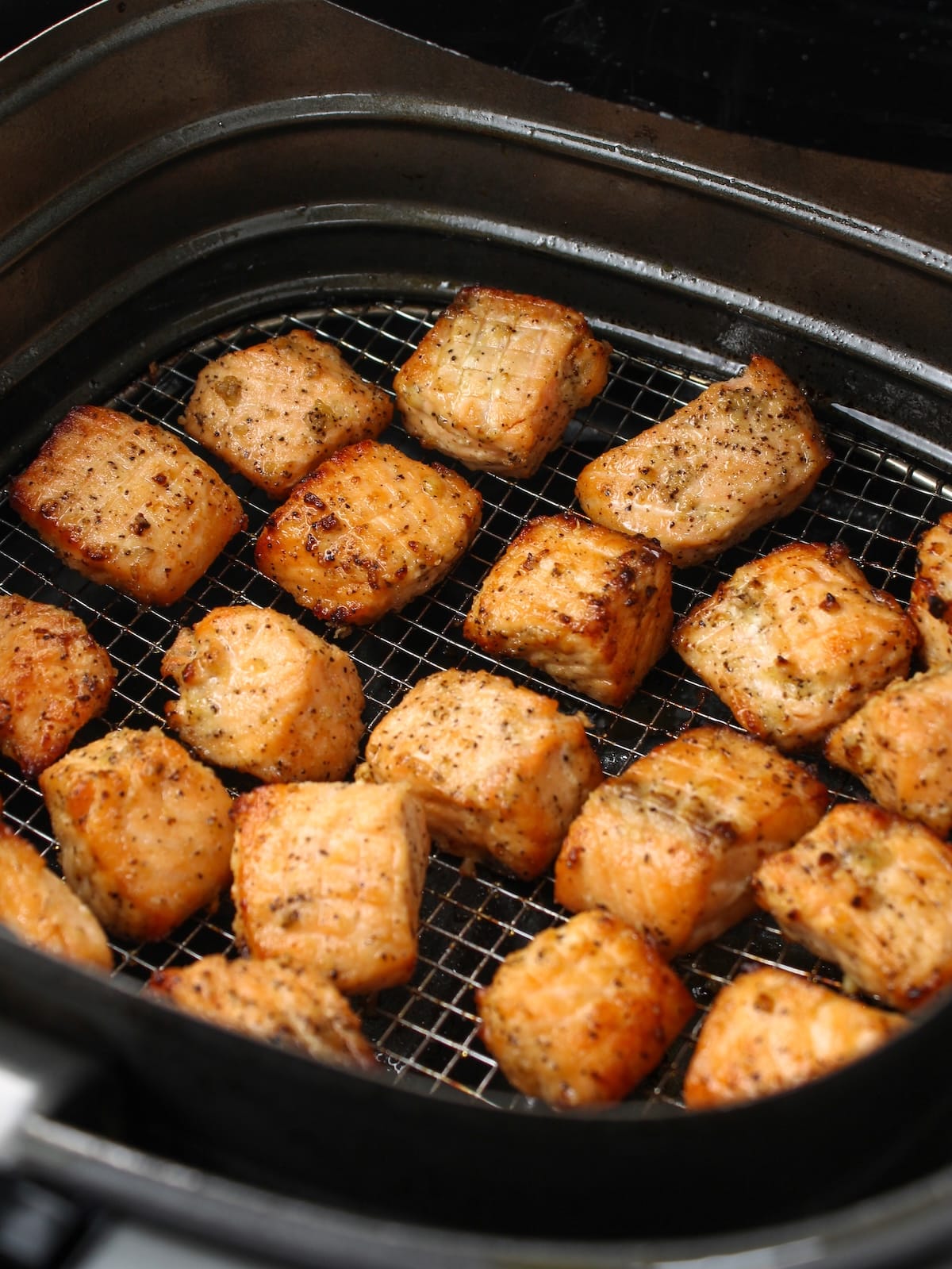 Salmon cut into 1 icnh pieces, seasoned and cooked in the air fryer.