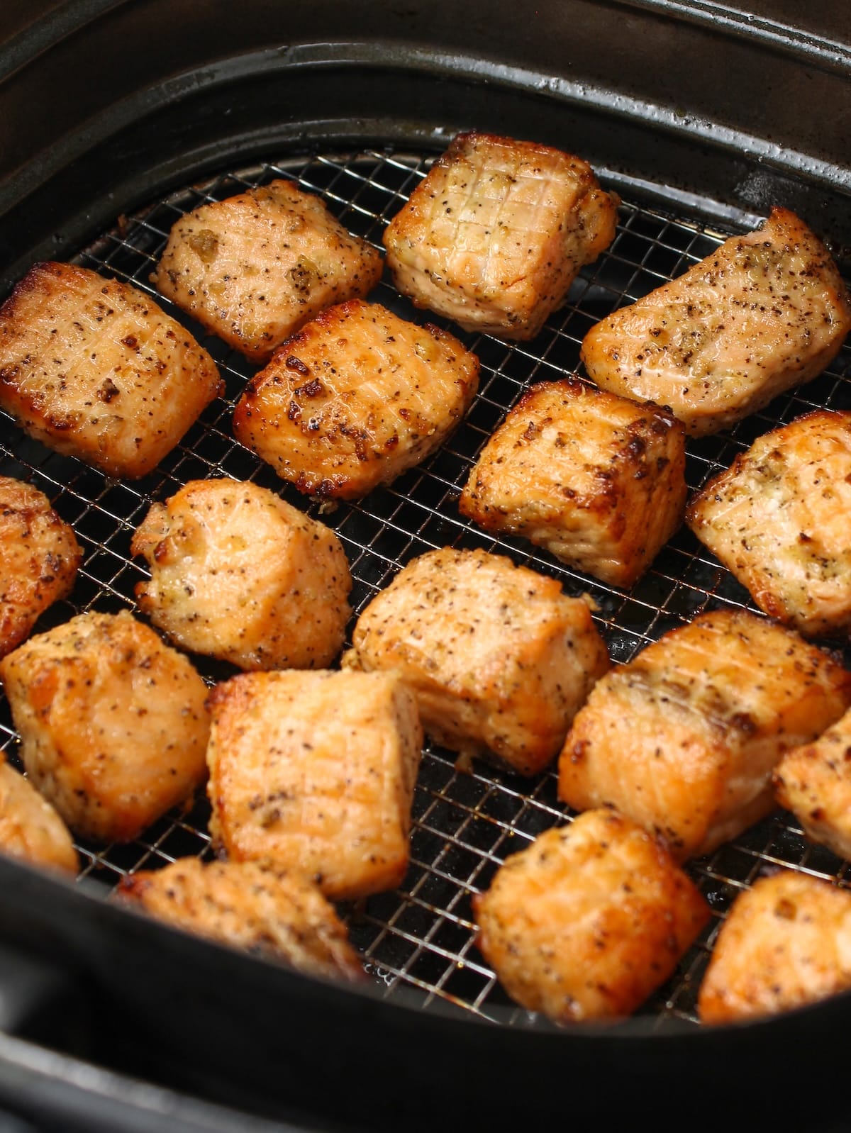 Close-up of cut up salmon air fried.