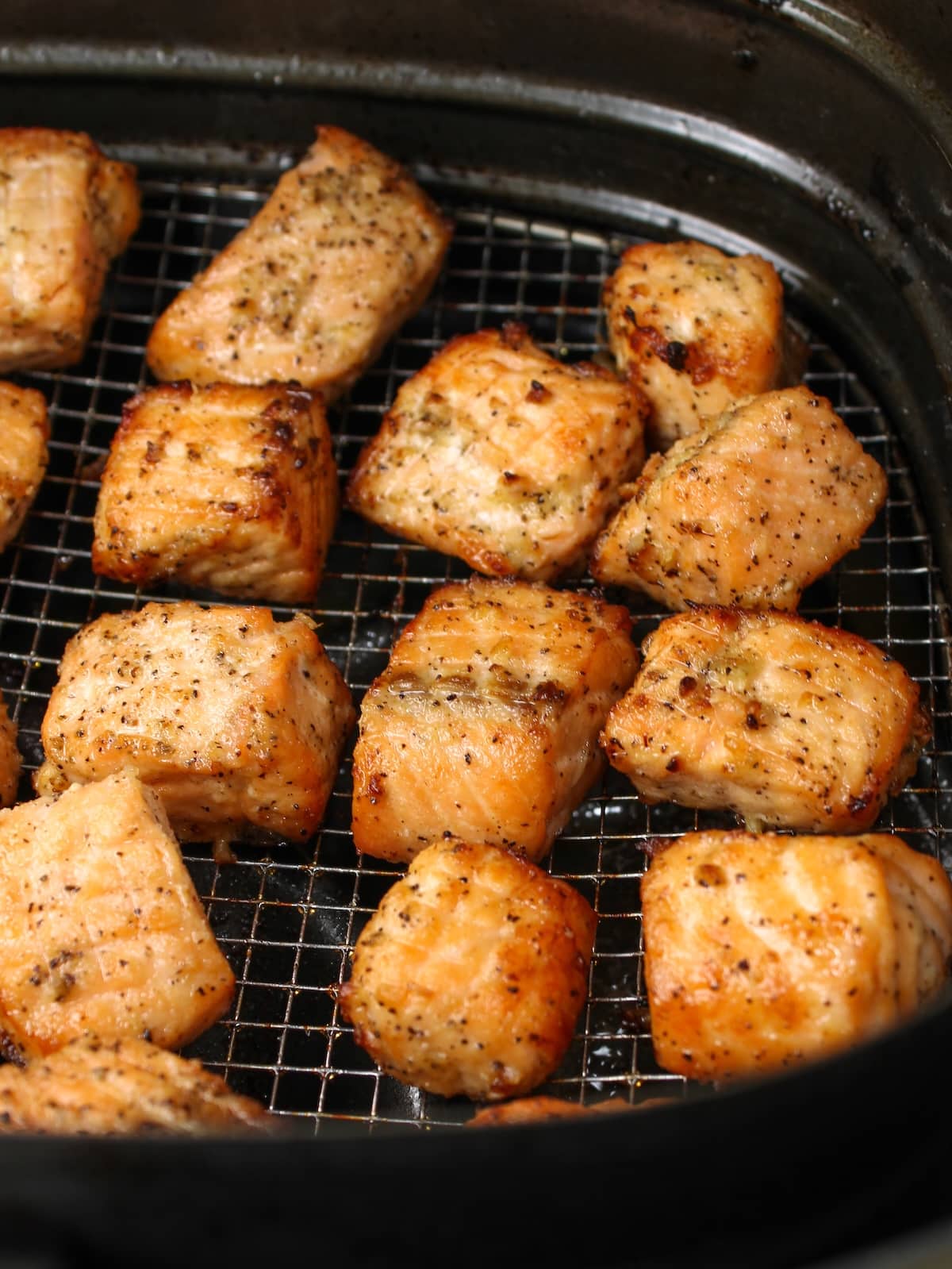 Salmon cut into 1 icnh pieces, seasoned and cooked in the air fryer.