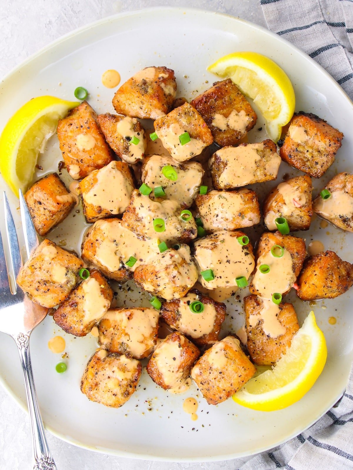 Salmon cut up into 1inch pieces, seasoned and cooked in the air fryer, then drizzeld with Bang Bang Sauce.