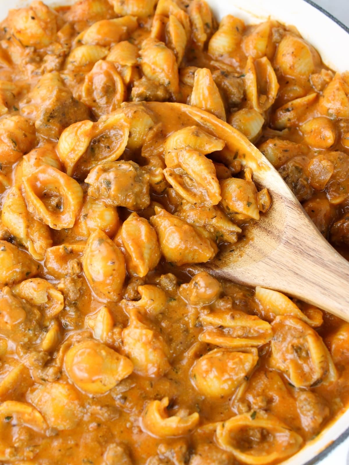 Creamy beef with pasta cooking in a skillet.