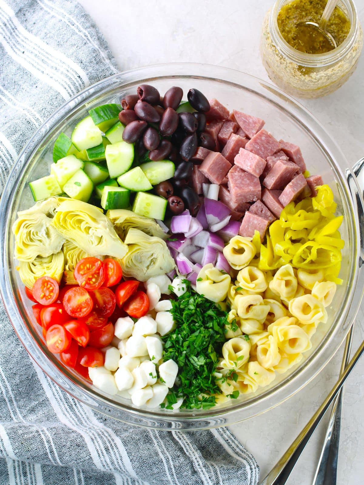 Ingredients for Italian Tortellini Pasta Salad Ingredients for Italian Tortellini Pasta Salad with the dressing on the side in a mason jar.