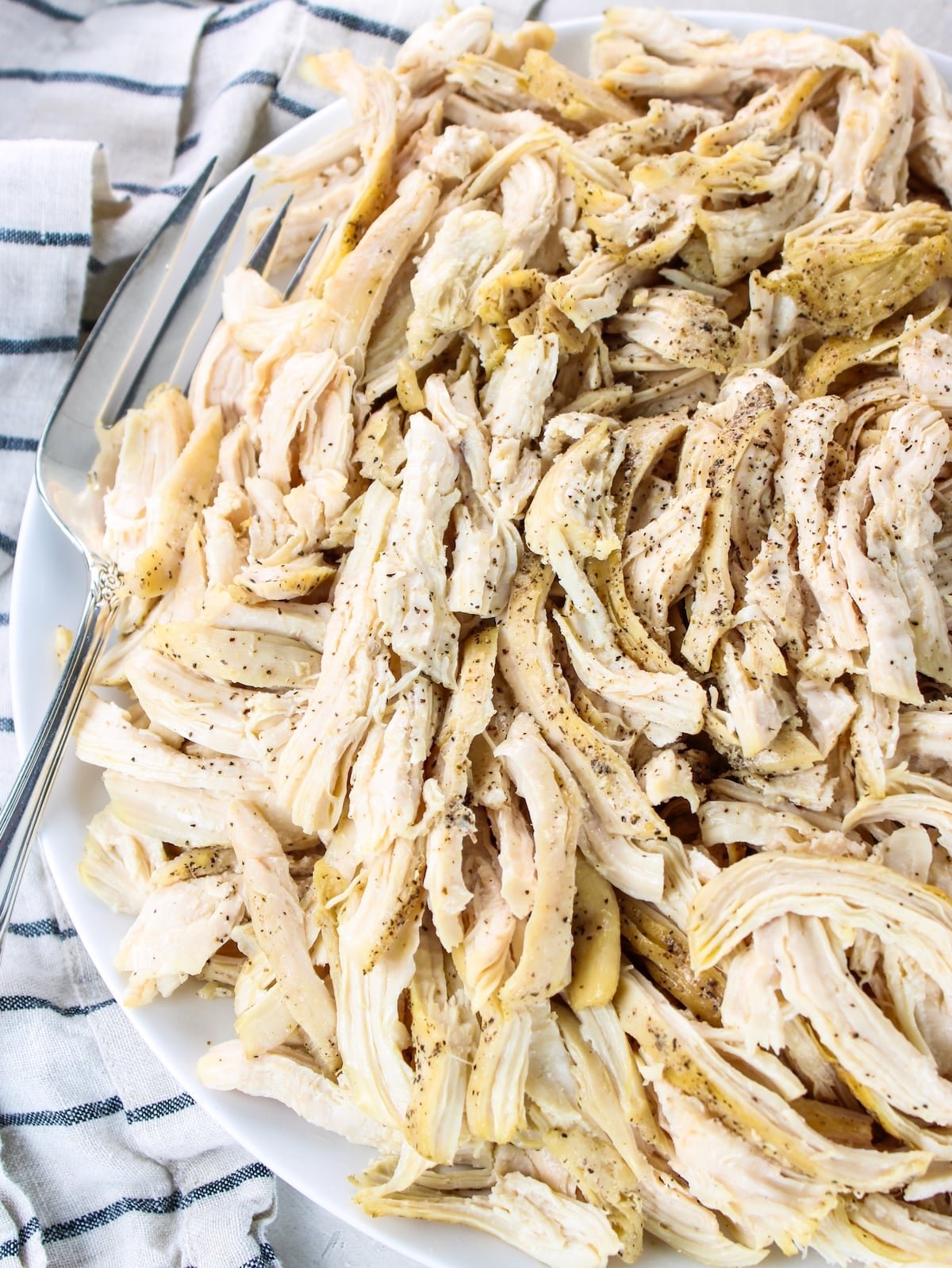 How to Make Juicy Shredded Chicken - pulled chicken on a platter.