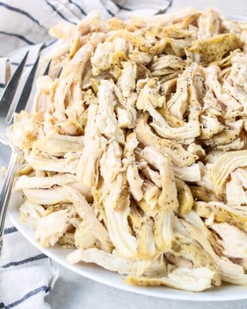 A photo of chicken breasts pulled on a platter.