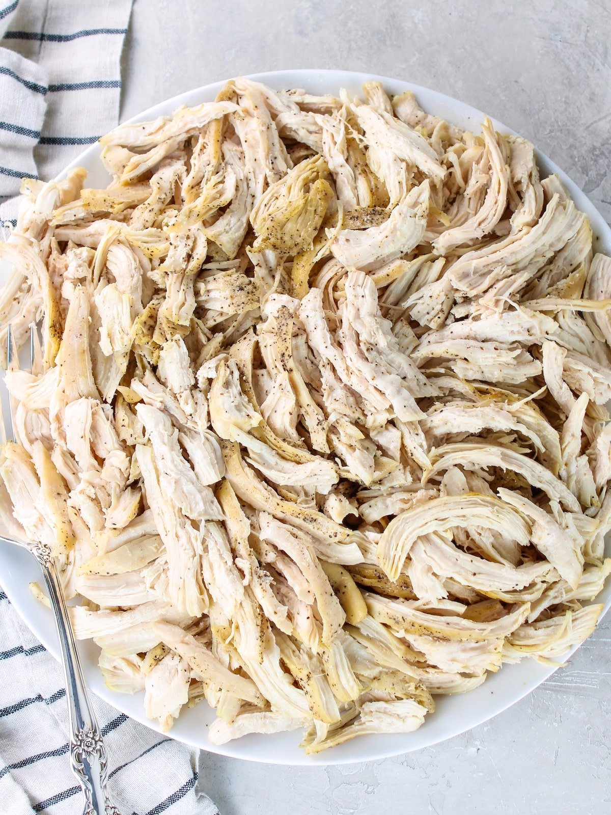 A platter with juicy shredded chicken breasts.