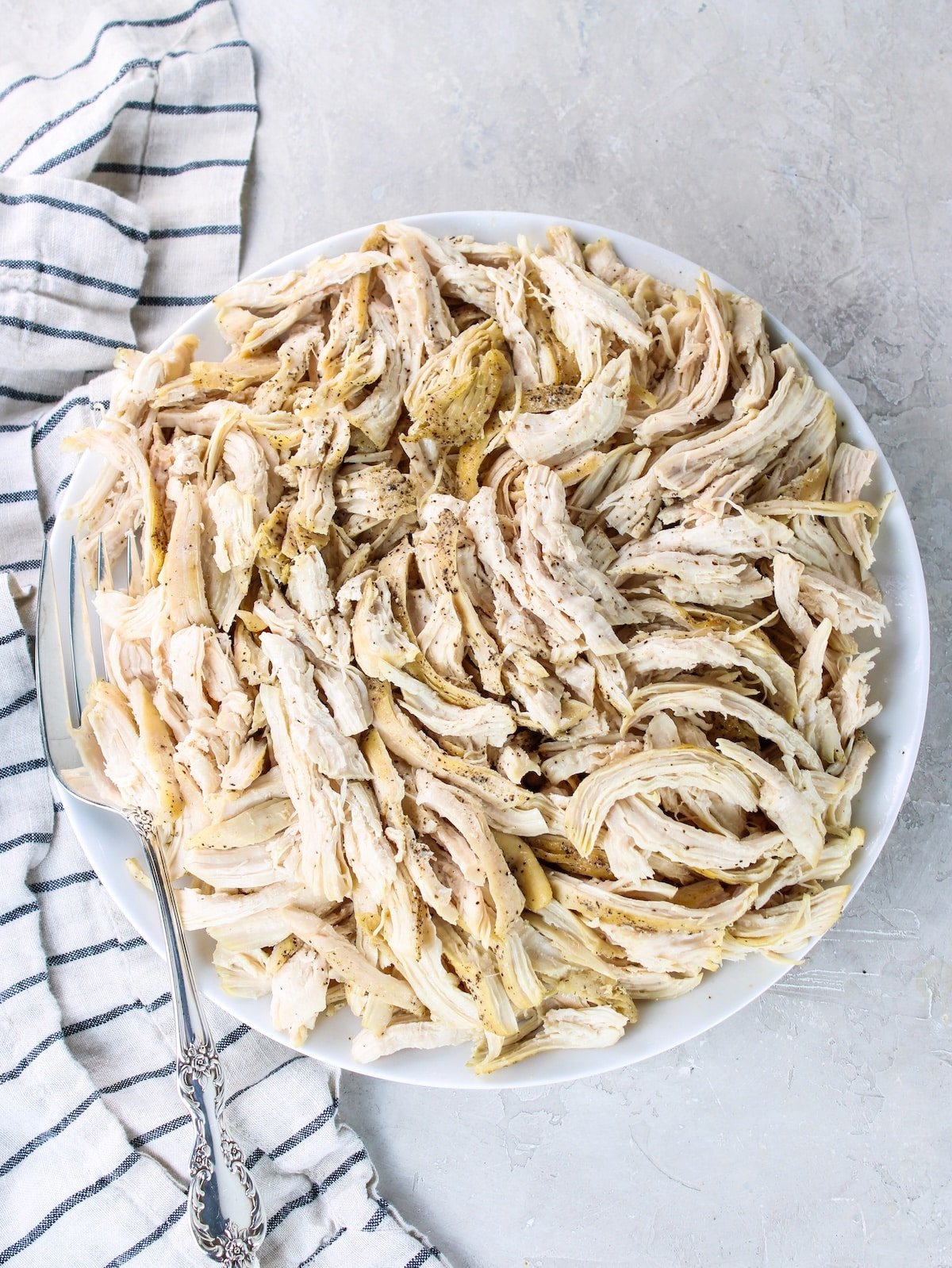 A platter with easy shredded chicken breasts.