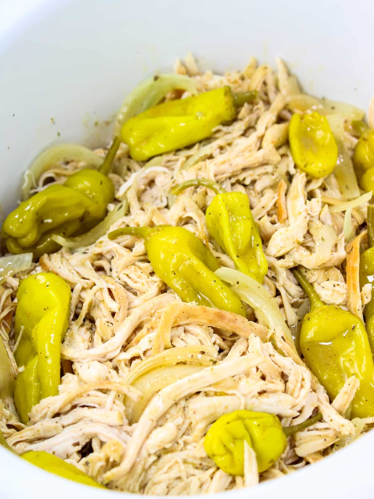 Shredded chicken breasts tossed in the sauce with onions and pepperincini peppers.