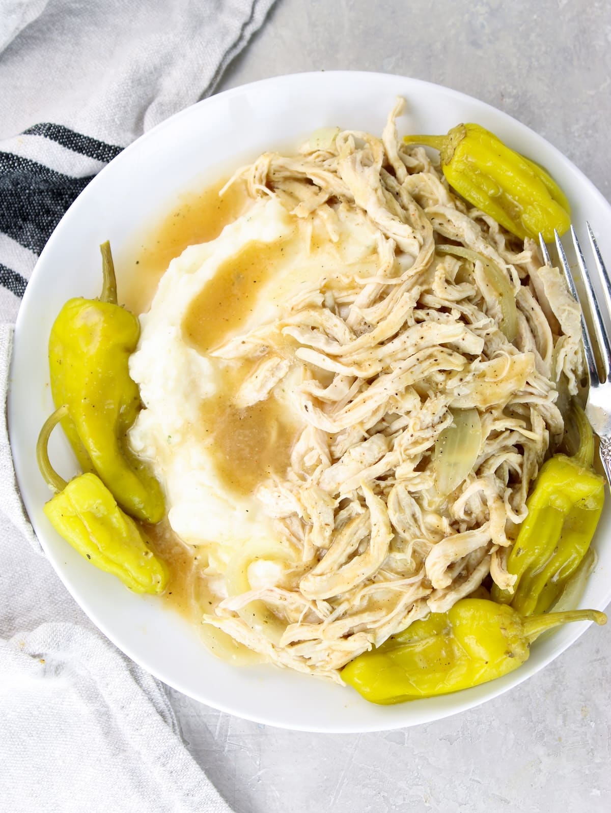 Easy Mississippi chicken recipe served over mashed potaotes.