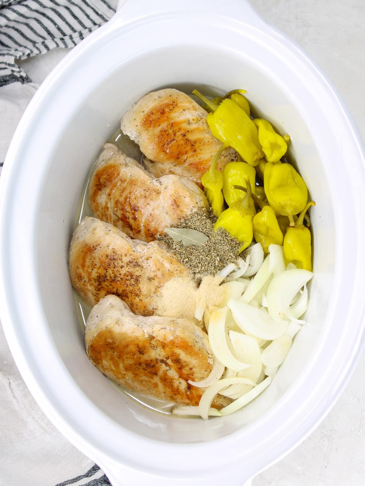 All the ingredients for Mississippi chicken in a slow cooker.