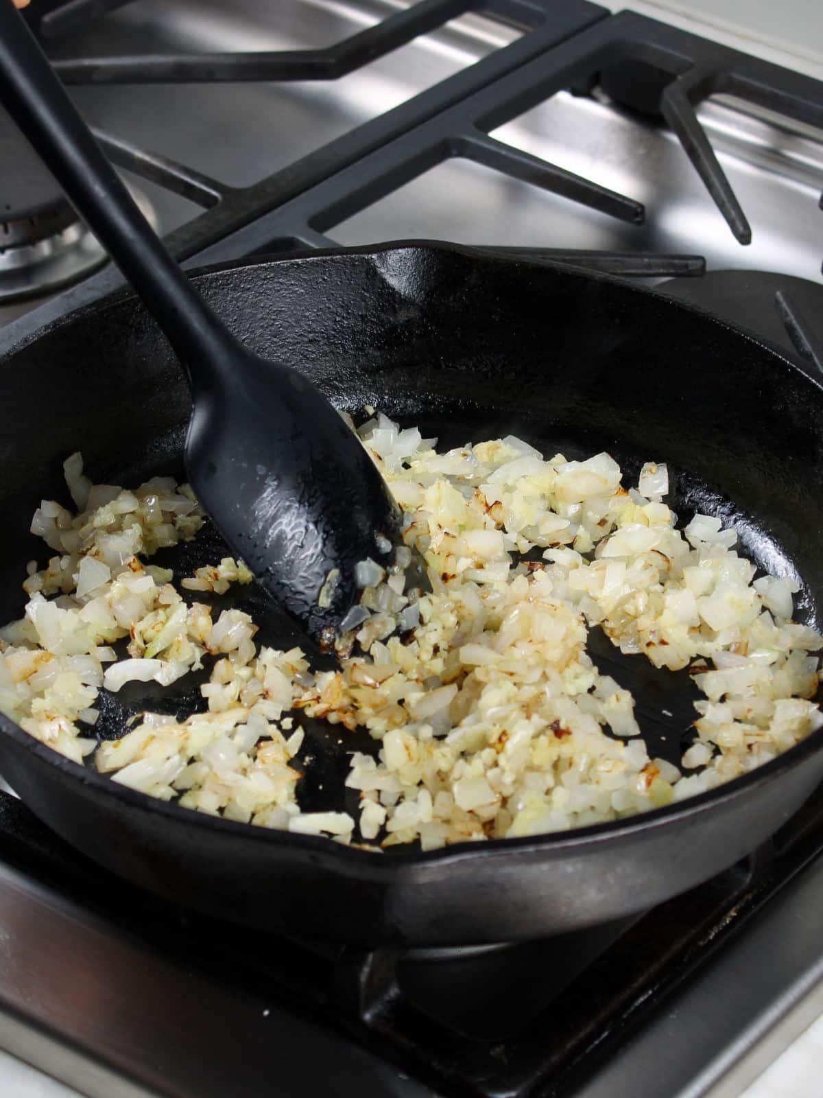 Sauteing garlic and onions in a skillet.