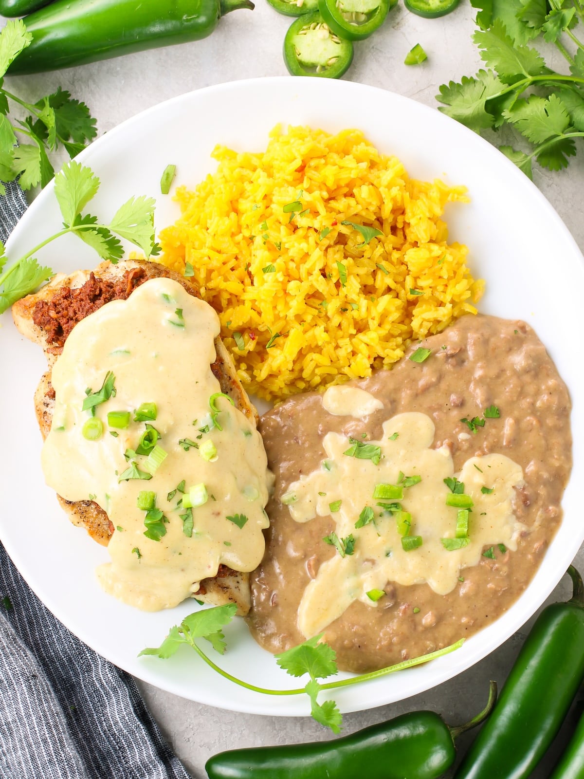 Plate of rice, refried beans, and a Chicken with Chorizo and cheese.