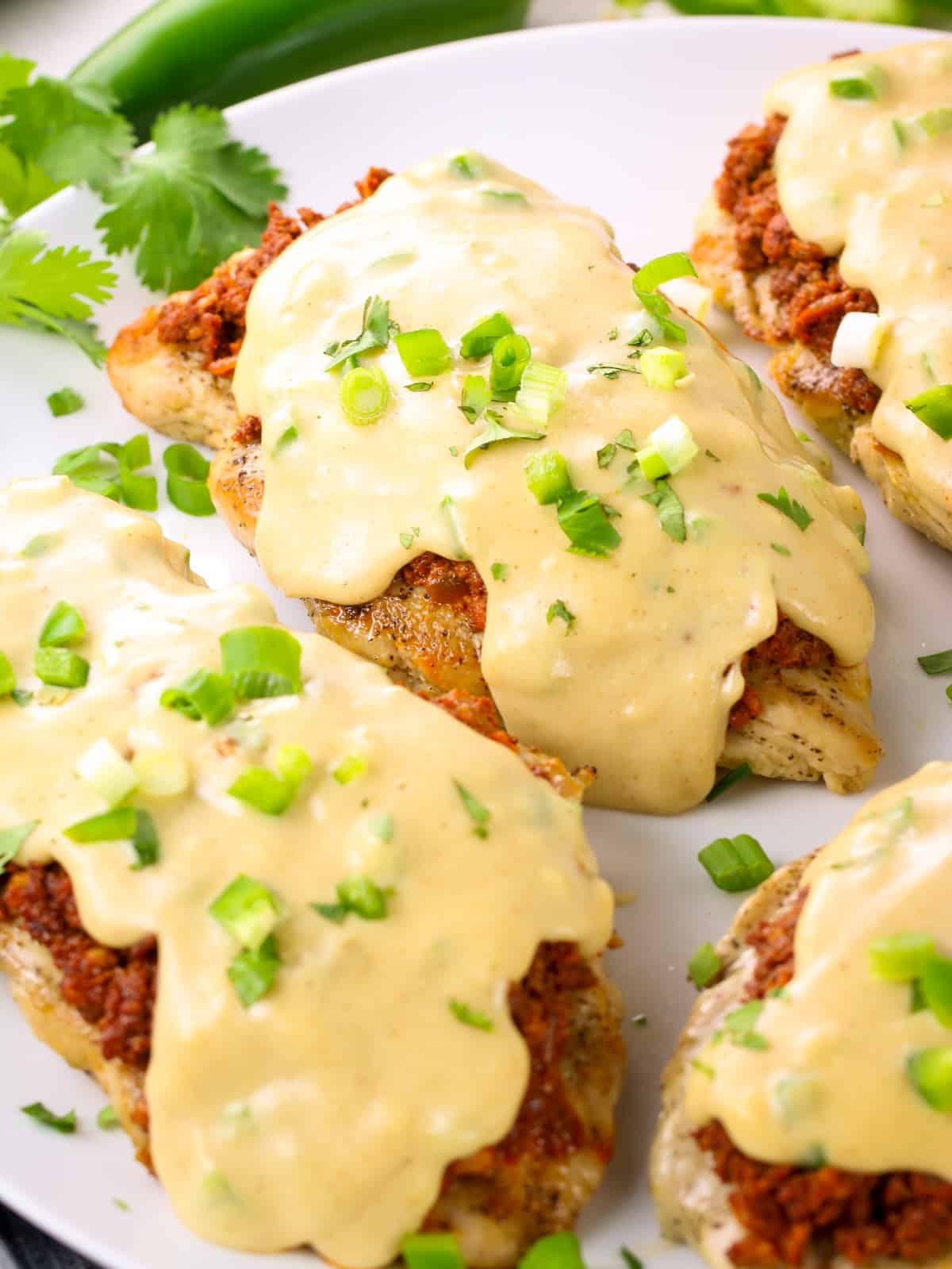 Partial platter with Chorizo Pollo Chicken covered in Cheese Sauce.