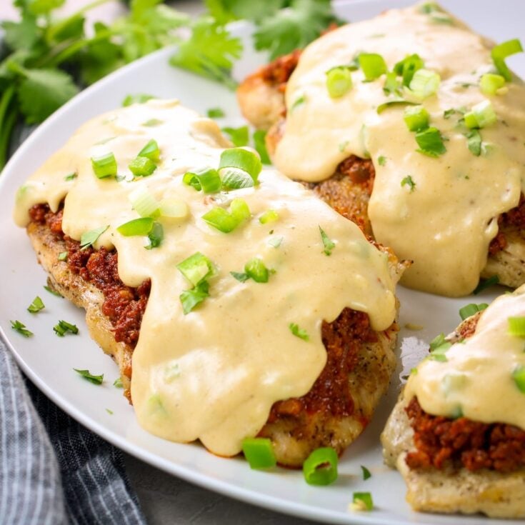 Partial platter of choripollo with cheese sauce. An easy and tasty Mexican chicken recipe.