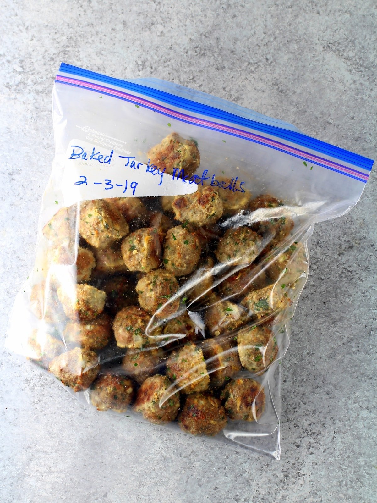A plastic freezer bag filled with freezer friendly turkey meatballs.