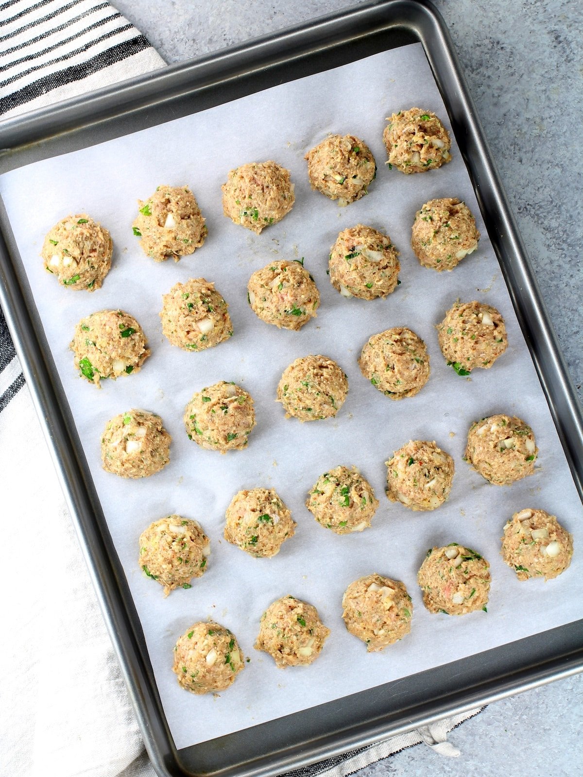 Easy turkey meatballs on a baking sheet lined with parchment paper.