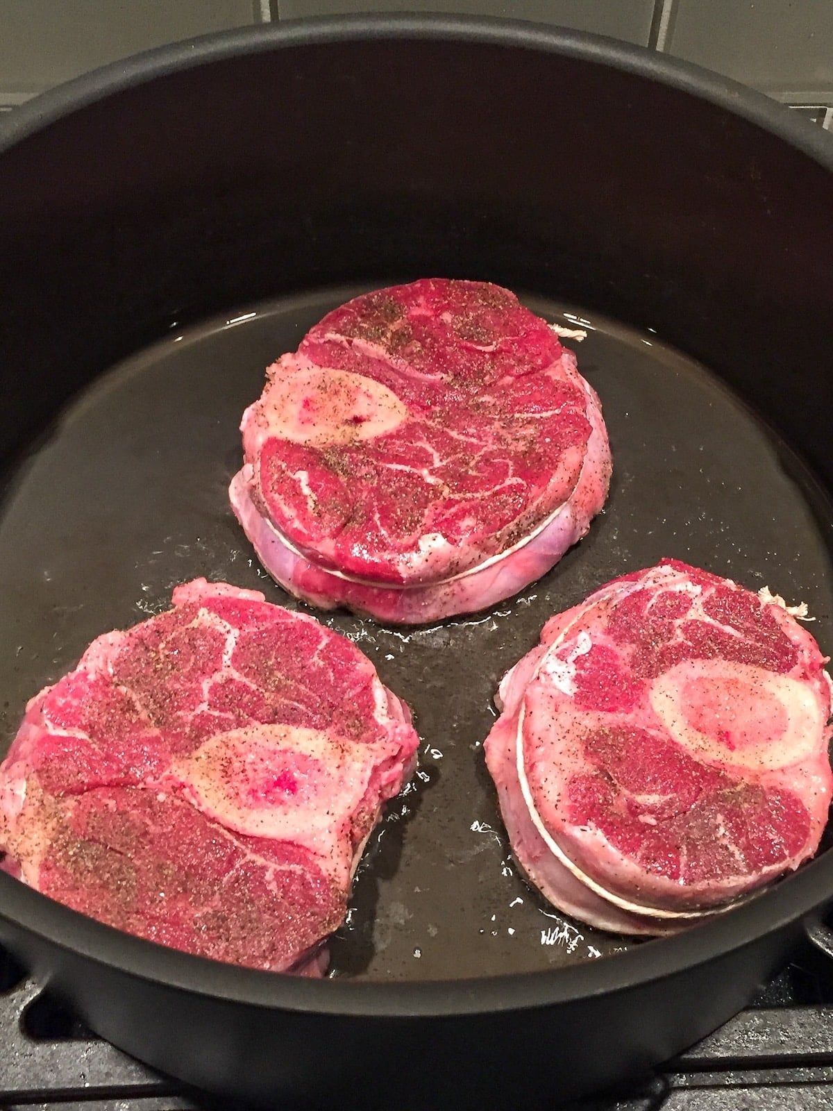 Veal for Osso Buco being seared in a Dutch oven.