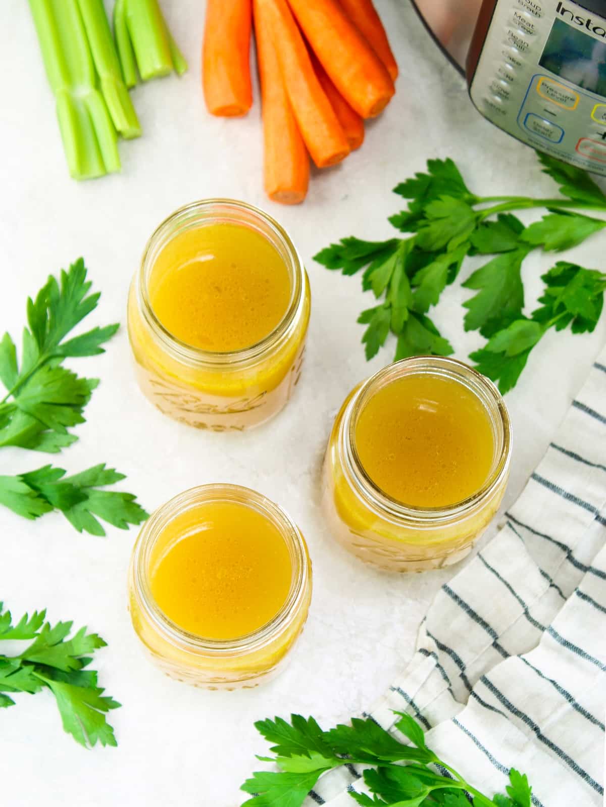 Glass jars filled with Instant Pot bone broth.