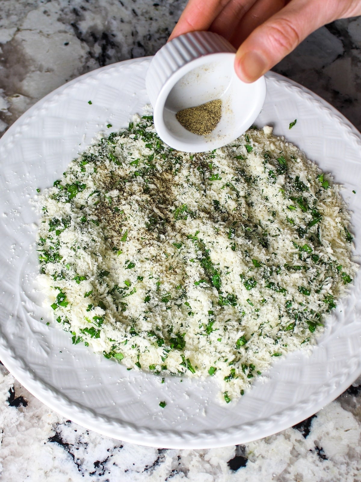 Fresh black pepper added to the bread crumb mixture for seasoning Parmesan crusted chicken.