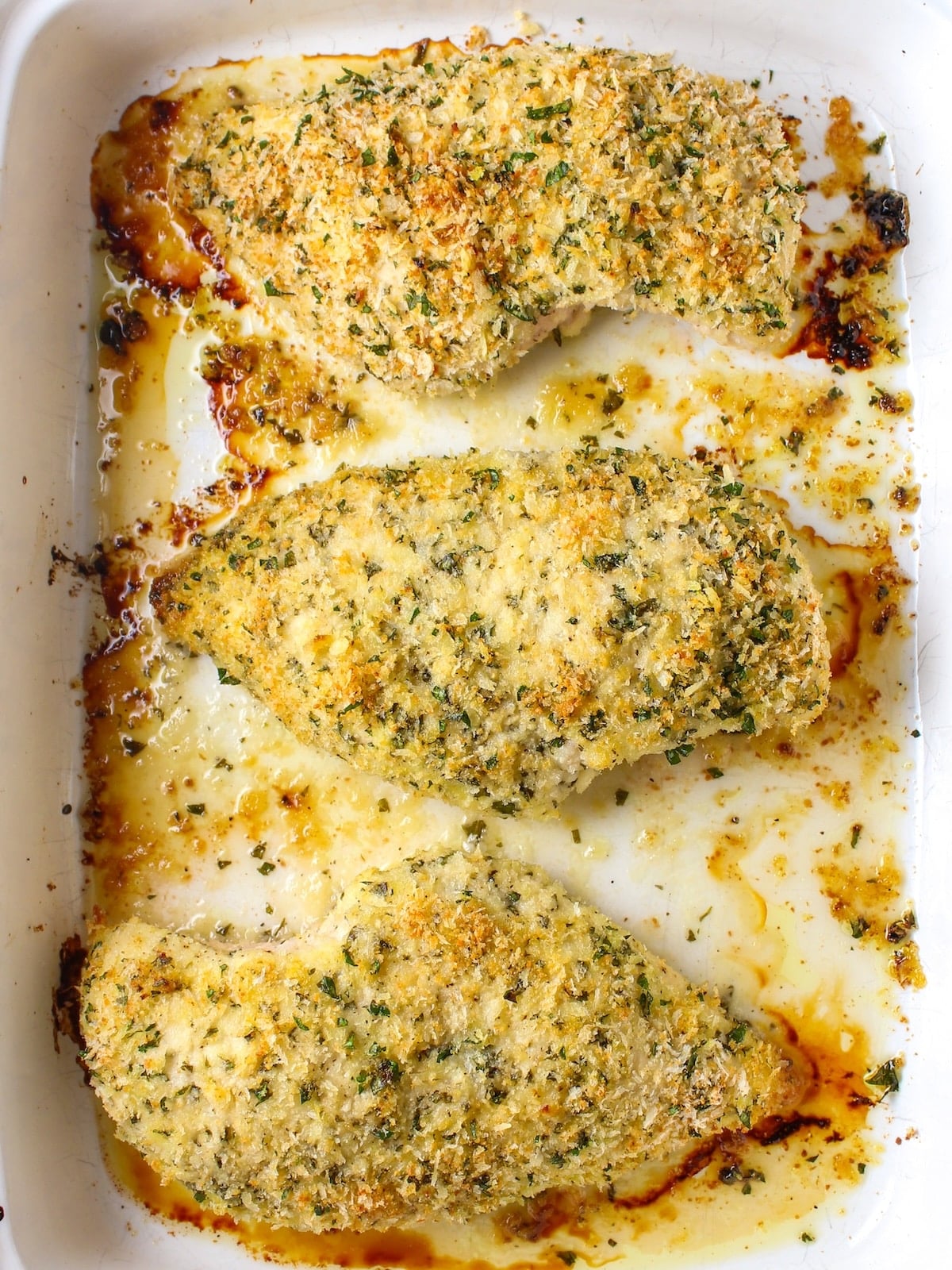 Parmesan crusted chicken breasts baked in a 9x13 casserole dish.