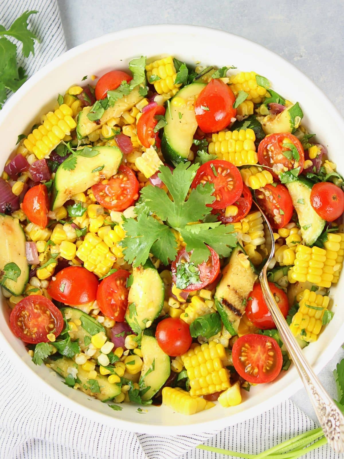 Grilled veggies corn salad with charred corn, zucchini, and peppers in a bowl — a smoky summer BBQ side dish