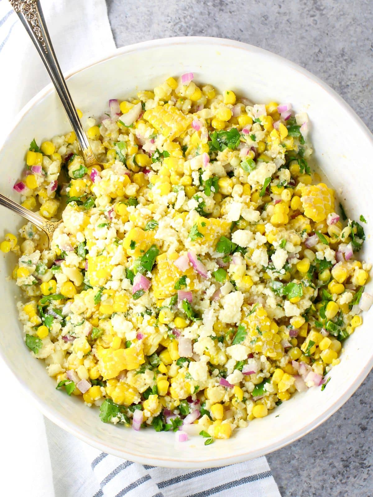 Creamy Mexican street corn salad with chili powder, cotija, and lime — an easy elote-style BBQ side dish recipe