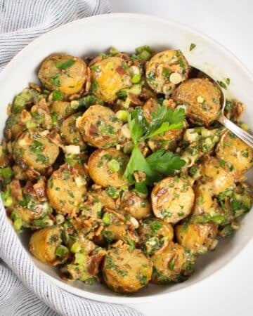 Salt and Vinegar Potato Salad with bacon, green onions, parsley, and tangy vinegar dressing